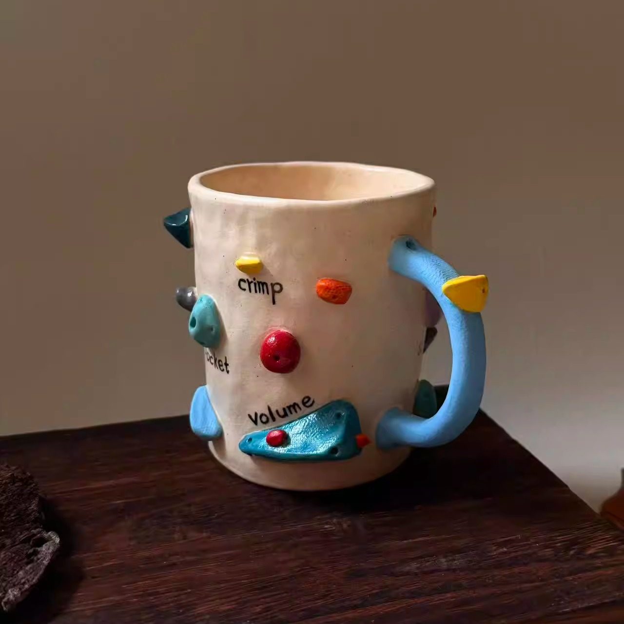 Handmade ceramic mug with rock climbing design, suitable for coffee, milk, and both hot and cold drinks.