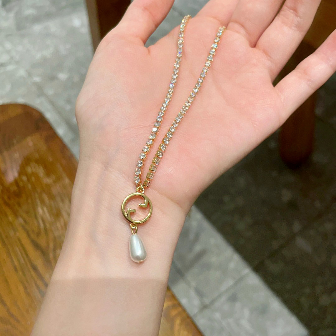 Gucci ring, pearl pendant, gold-tone necklace with diamonds