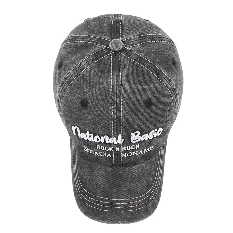 Fashionable washed denim baseball cap with wide brim, a curved visor, and sun protection.