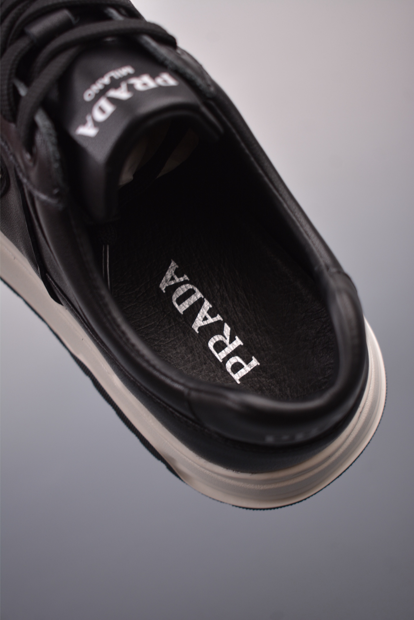 Prada PRAX 01 Triangle Logo Leather Sneakers Black and White D933M_3LF5_FG000