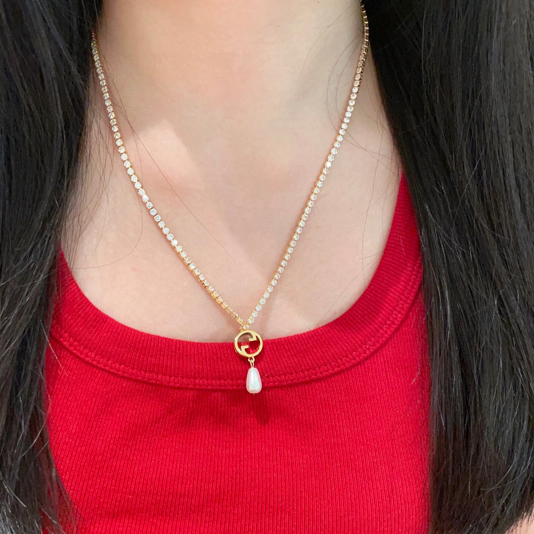 Gucci ring, pearl pendant, gold-tone necklace with diamonds