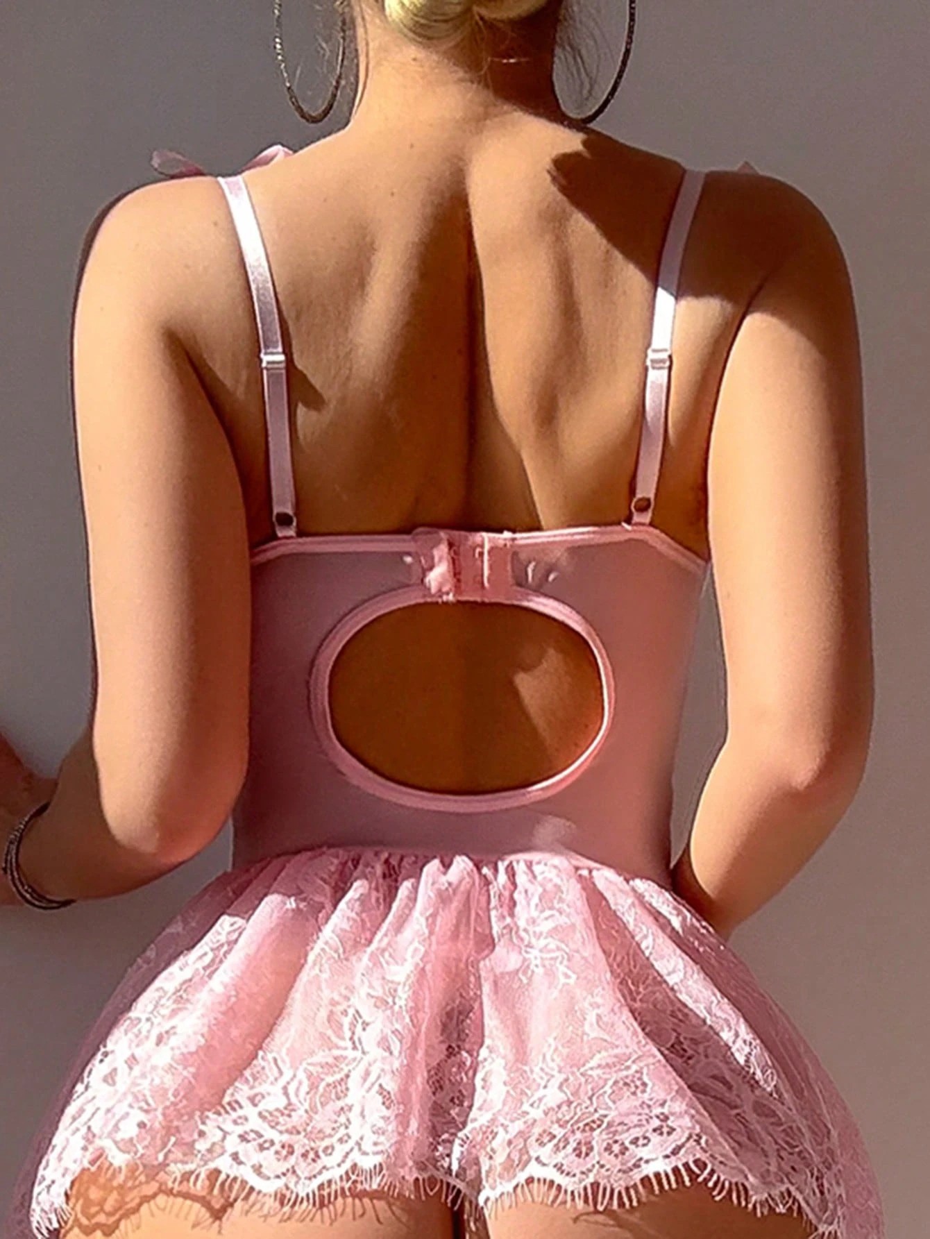 Pure and seductive pink bodysuit with fishtail straps, a seductive and alluring lingerie set.