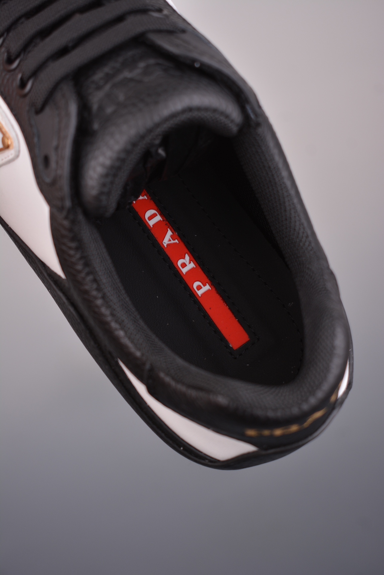 Prada Downtown Low Sneakers in black and white pebbled leather