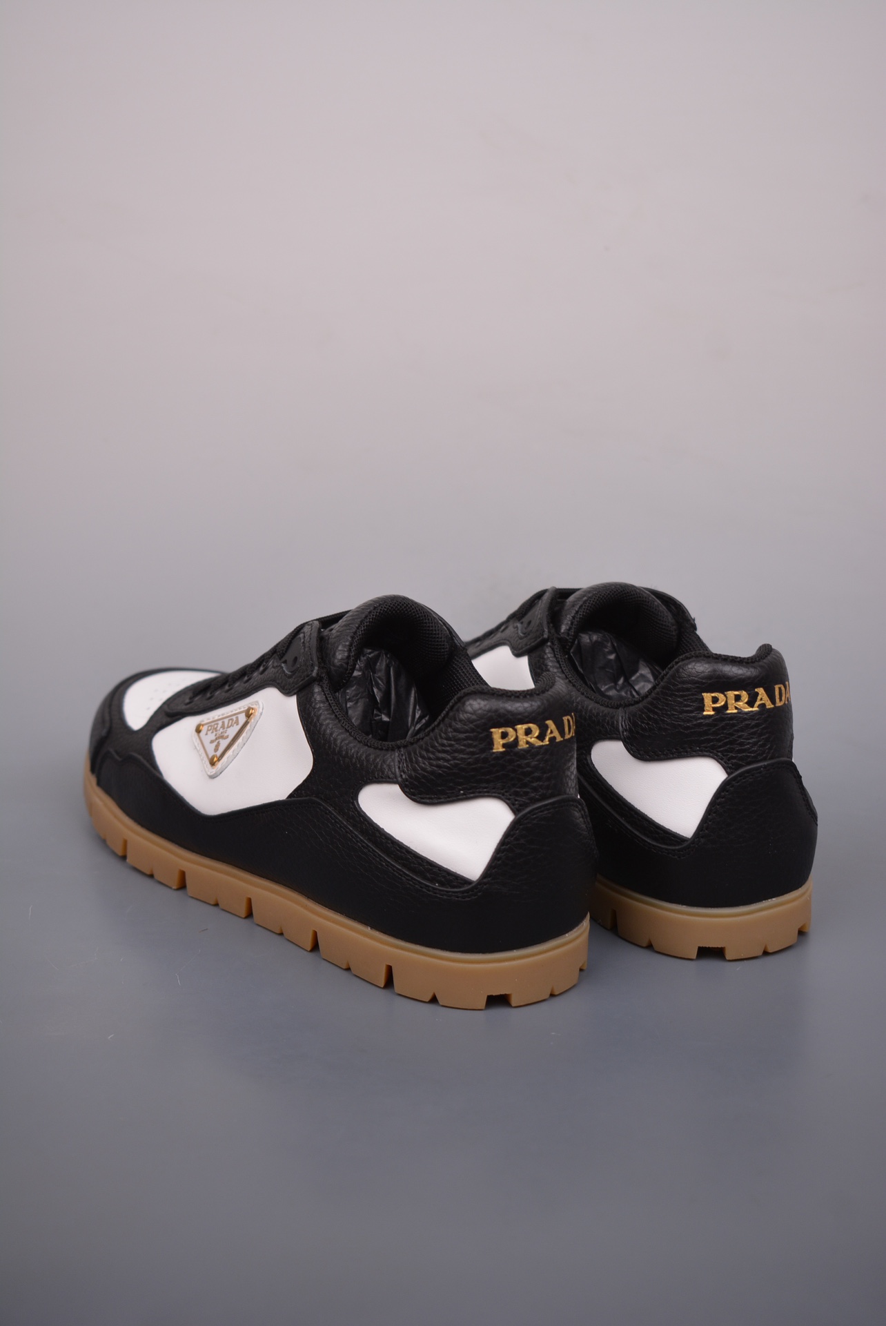 Prada Downtown Low Sneakers in black and white pebbled leather