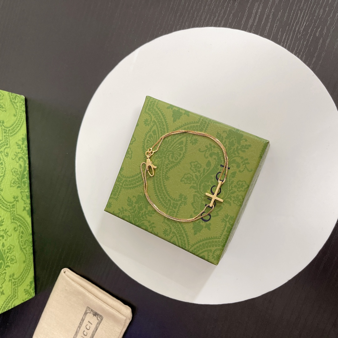 Gucci gold-tone cross bracelet