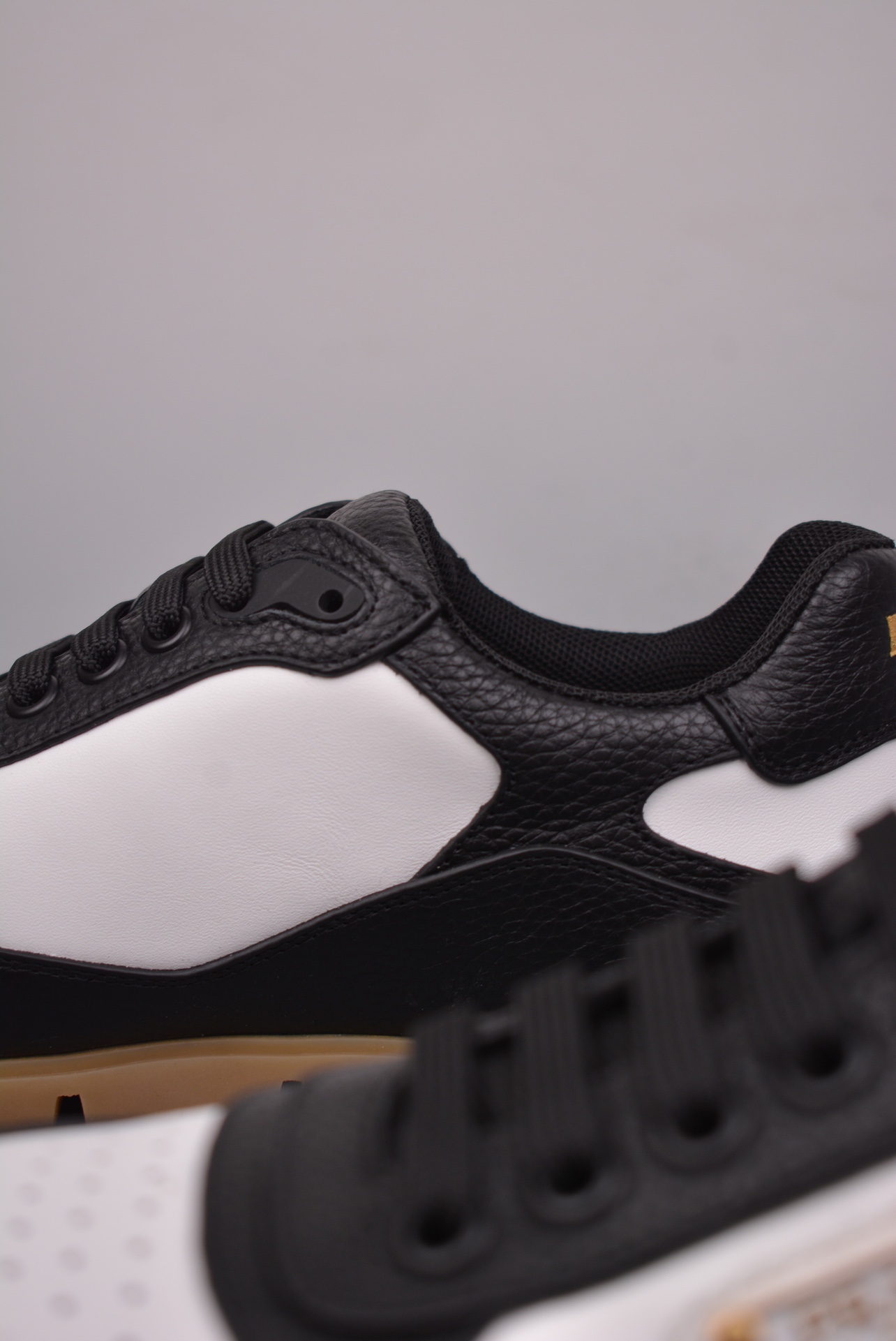 Prada Downtown Low Sneakers in black and white pebbled leather