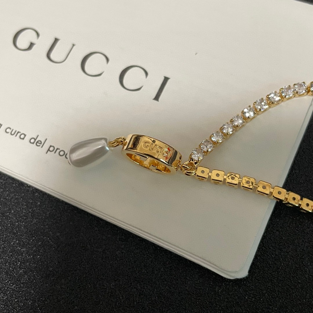 Gucci ring, pearl pendant, gold-tone necklace with diamonds