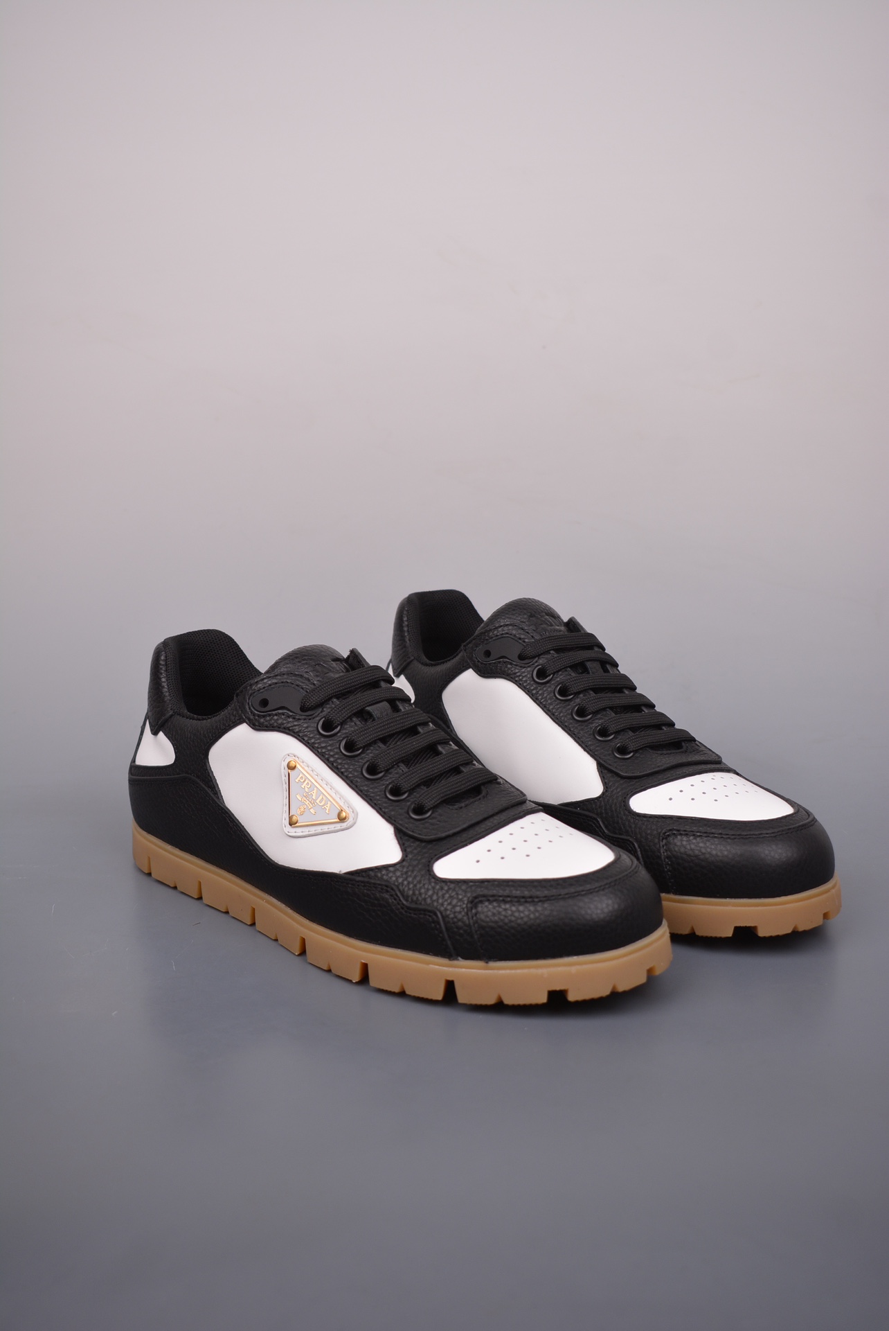 Prada Downtown Low Sneakers in black and white pebbled leather