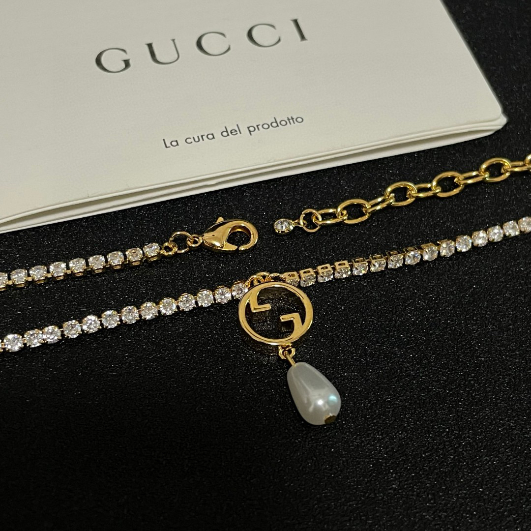 Gucci ring, pearl pendant, gold-tone necklace with diamonds