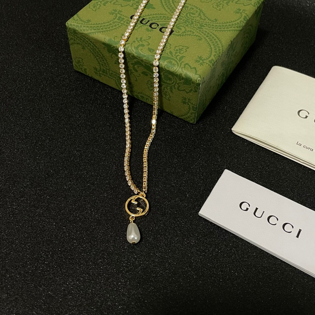Gucci ring, pearl pendant, gold-tone necklace with diamonds