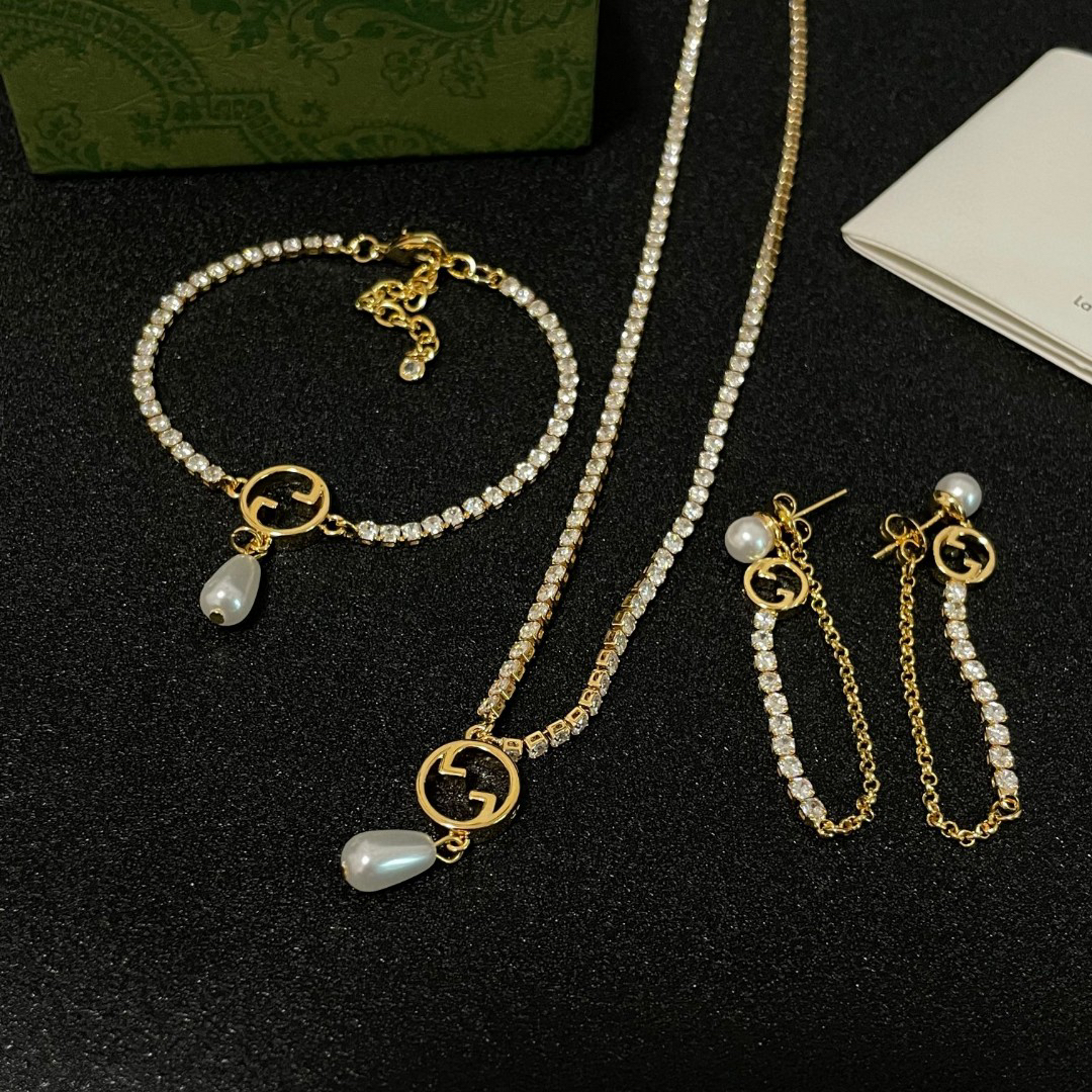 Gucci ring, pearl pendant, gold-tone necklace with diamonds