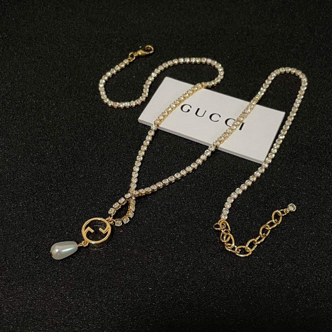 Gucci ring, pearl pendant, gold-tone necklace with diamonds