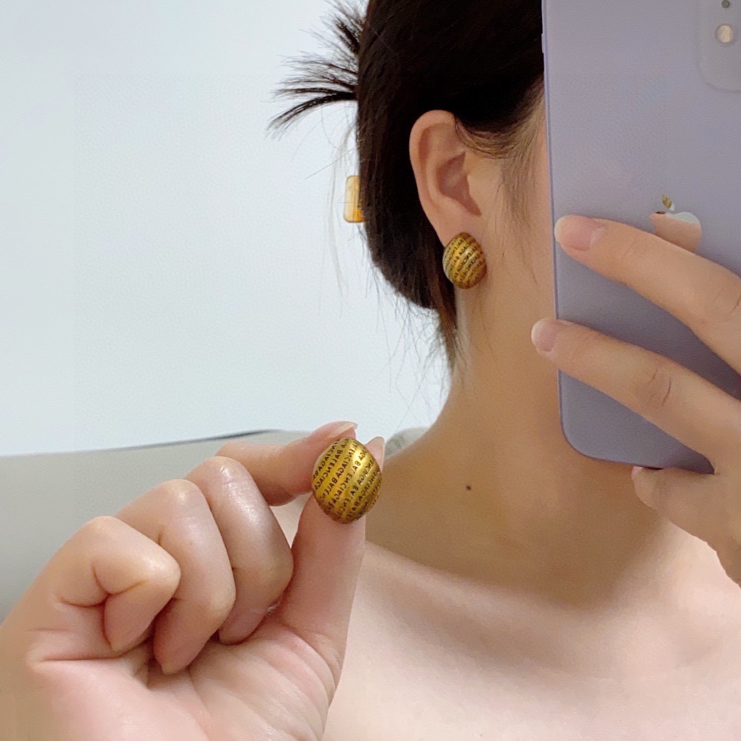 Balenciaga antique gold engraved letter earrings