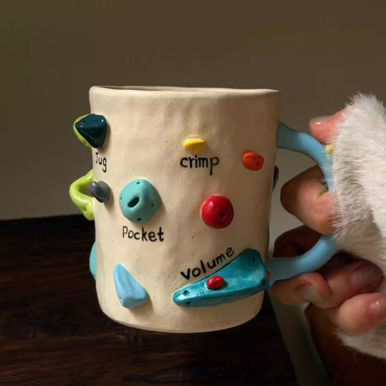 Handmade ceramic mug with rock climbing design, suitable for coffee, milk, and both hot and cold drinks.