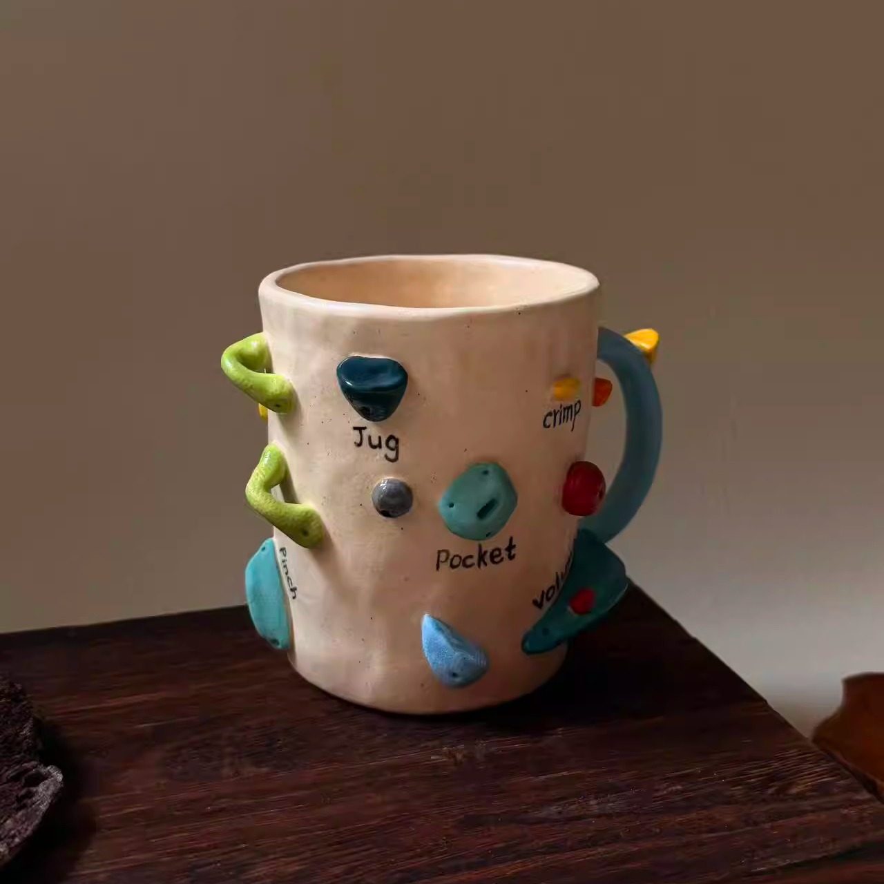 Handmade ceramic mug with rock climbing design, suitable for coffee, milk, and both hot and cold drinks.