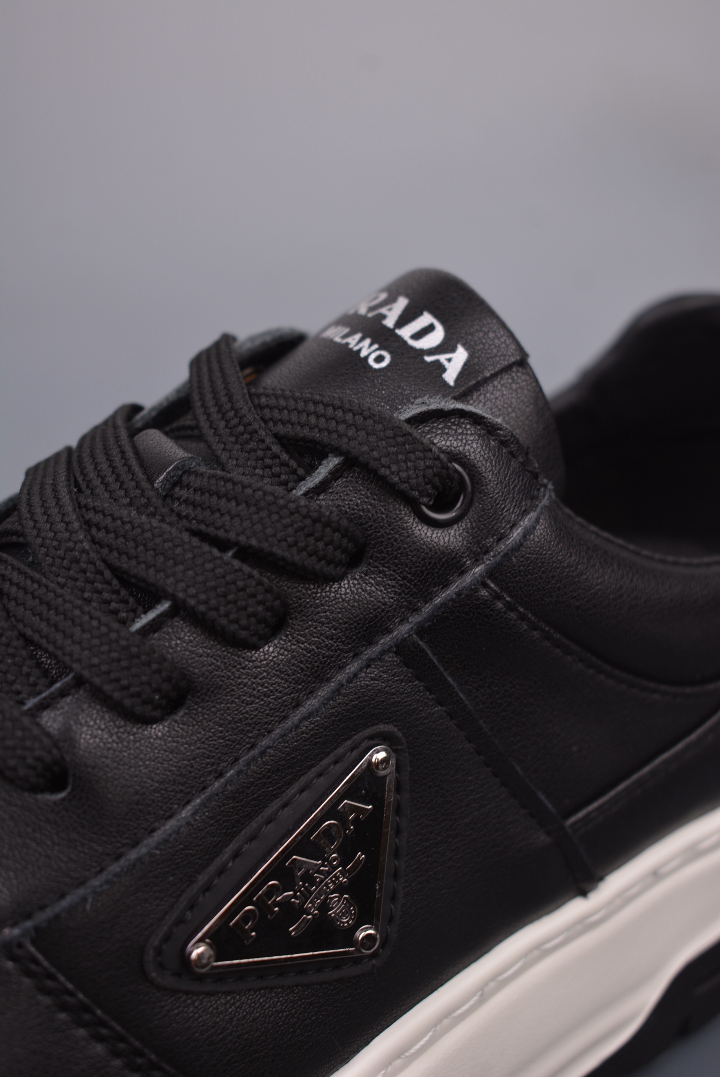 Prada PRAX 01 Triangle Logo Leather Sneakers Black and White D933M_3LF5_FG000