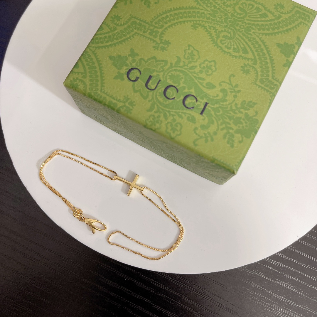 Gucci gold-tone cross bracelet