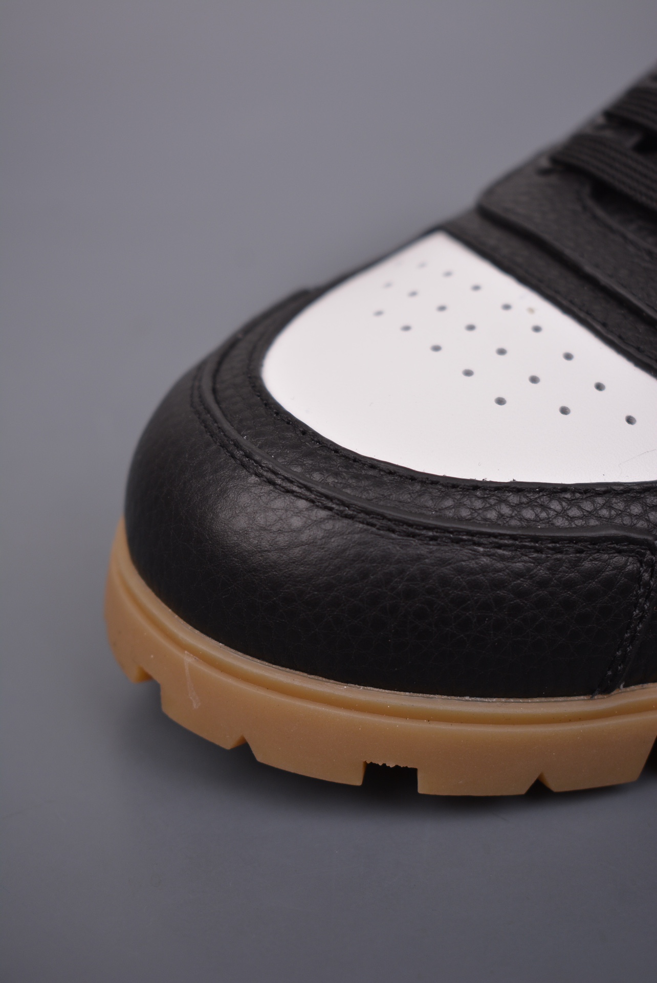 Prada Downtown Low Sneakers in black and white pebbled leather