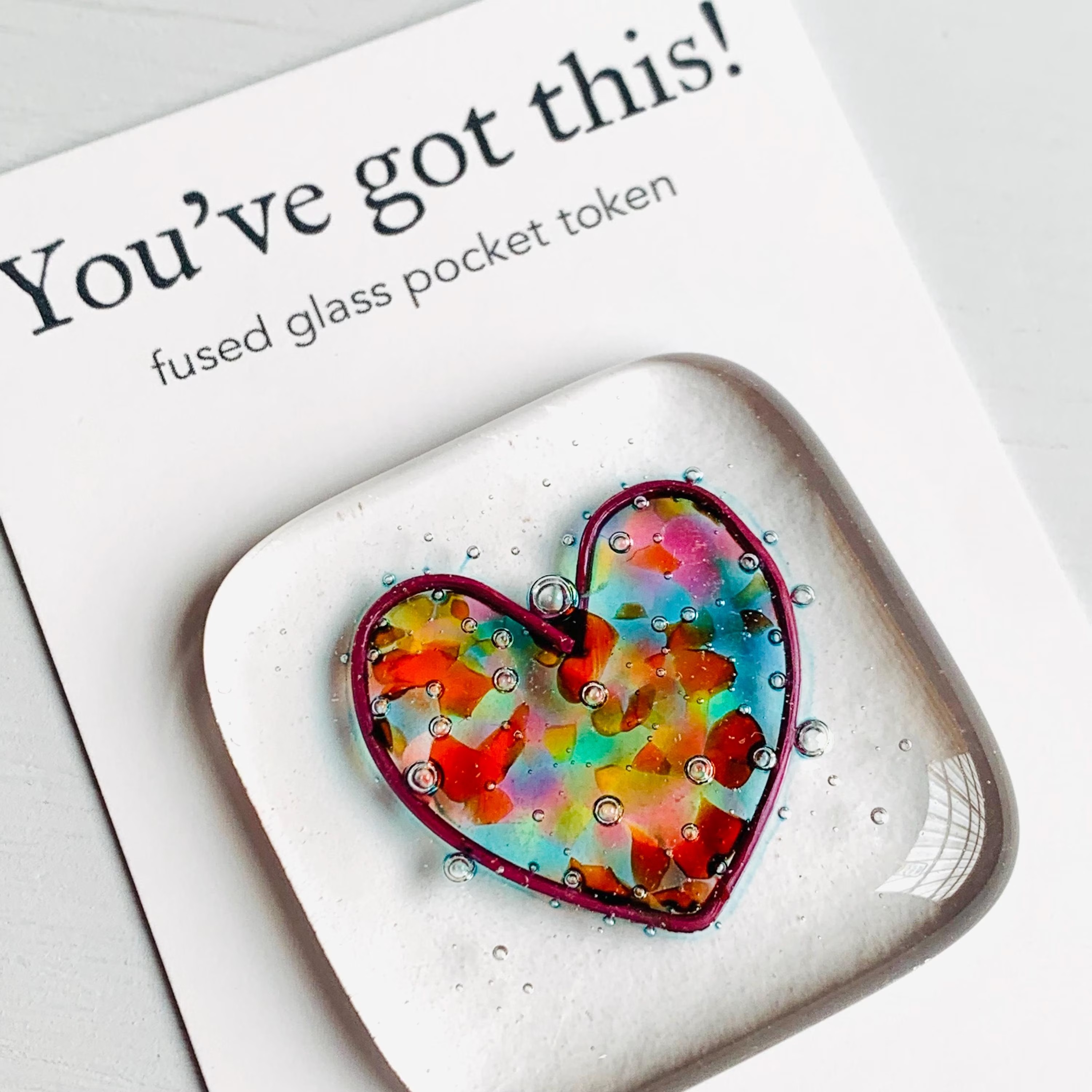 A glass pocket token with information