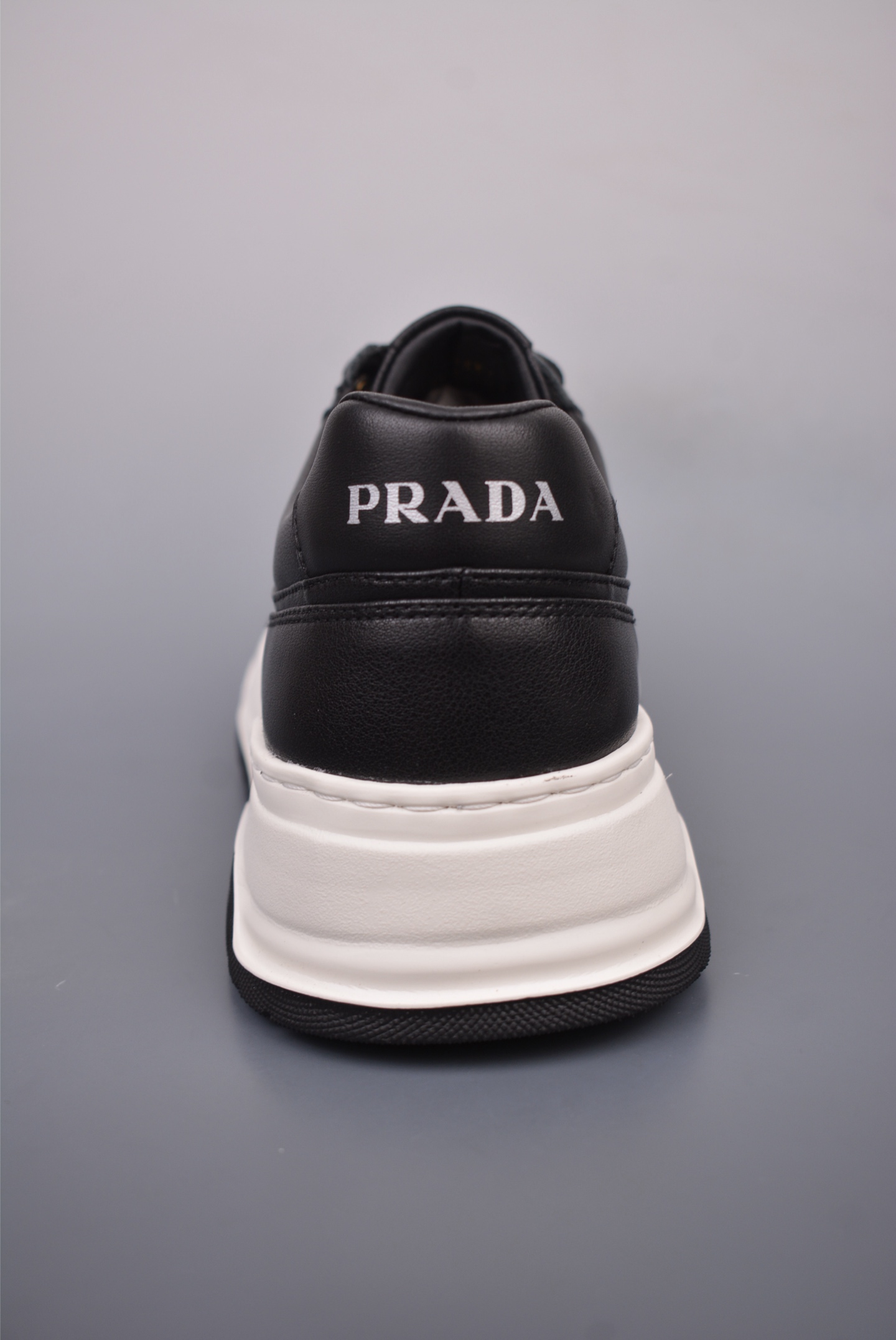Prada PRAX 01 Triangle Logo Leather Sneakers Black and White D933M_3LF5_FG000